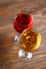 Glasses with wines of different colors on a wooden table