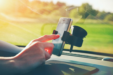 hand using smart phone as gps navigation while car driving