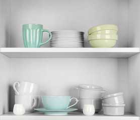 Fototapeta na wymiar Dishes in cupboard in the kitchen