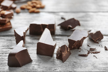 Chocolate pieces on wooden background