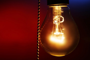 Light bulb on color background, close up