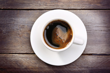 Cup of fresh coffee on wooden background