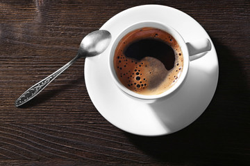 Cup of fresh coffee on wooden background