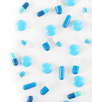 Blue pills on white background