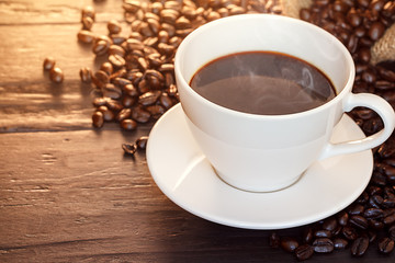 Hot cup coffee on brown background.