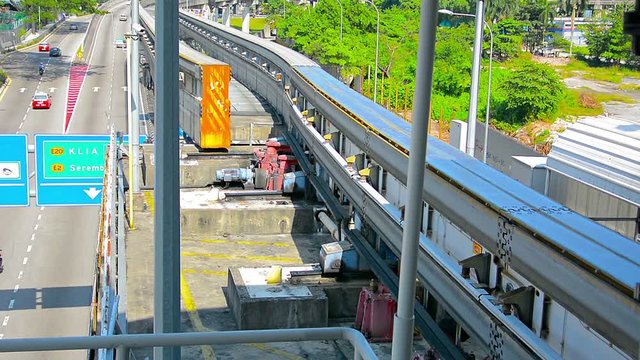 FullHD video - Remote, automated switching system mechanically switches lines for an elevated monorail track over a busy highway.