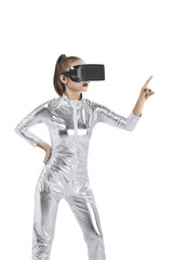 Beautiful young woman in silver latex costume and VR headset