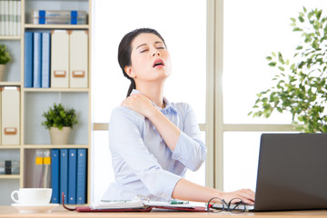 Young asian business woman with pain in shoulders