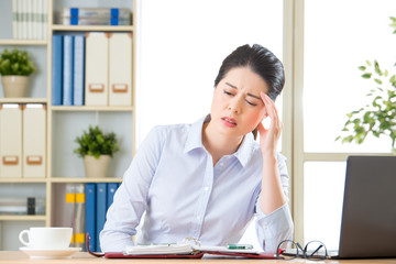 Young asian business woman with headache © PR Image Factory