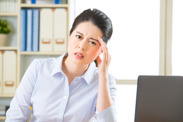 Young asian business woman with headache