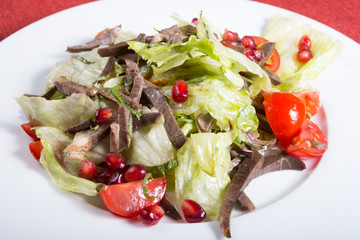 Meat salad with lettuce and pomegranate