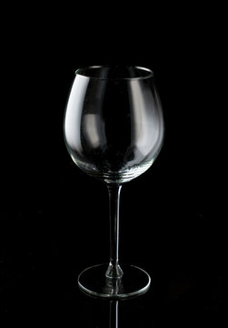 Clean, empty wine glass on a black background