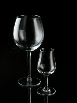 Different glasses - wine and whiskey on a black background