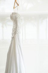 white wedding dress holding in the room