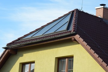 Obraz premium Solar panels for water heating installed on the roof of family house