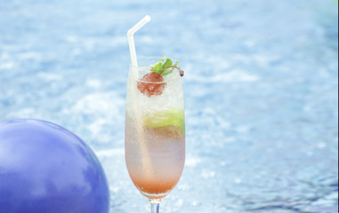 Mojito cocktail  on a swimming pool, cherry
