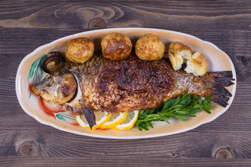 Fried fish carp on the plate
