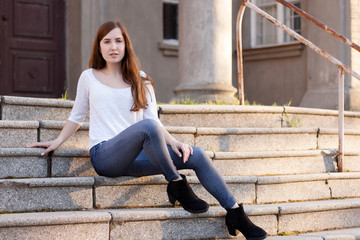 Young girl sitting on the stairs