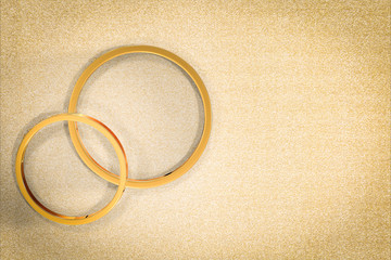 golden wedding rings on gold background