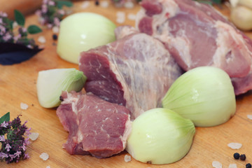 Fresh raw meat on a platter with herbs