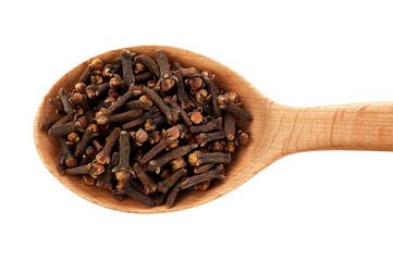 Spice cloves on wooden spoon isolated on white background.