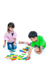 Children playing toy wood blocks, isolated on white background.