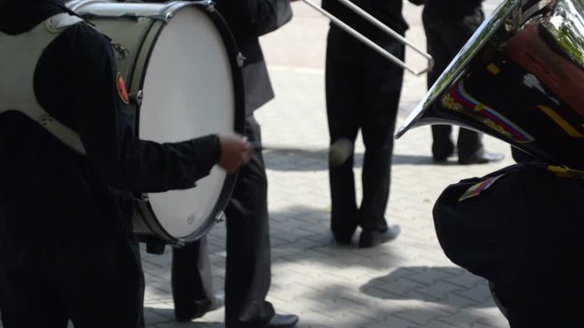 Military navy band drummer playing bass drum 
