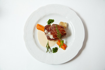 Grilled steak with carrots, close up isolated on white
