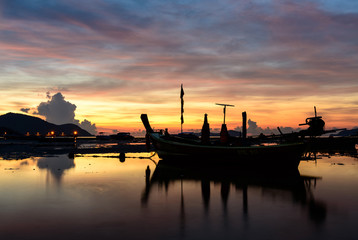 Fototapeta na wymiar Fishing boats on the beach. In the morning Sunrise in Phuket Thailand