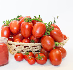 Bunch of tomatoes in a basket with tomato juice