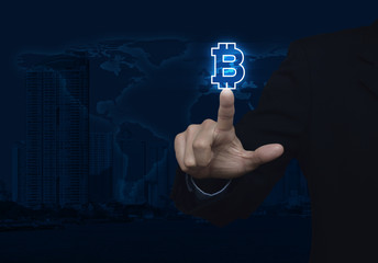 Businessman pressing bitcoin icon over map and city background,