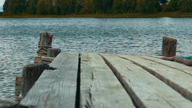Old Wooden Pier With Motor Boad Near it