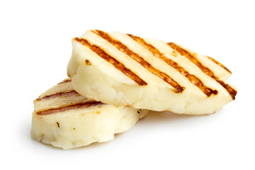 Two grilled slices of halloumi cheese isolated on white in perspective. With grill marks. - obrazy, fototapety, plakaty