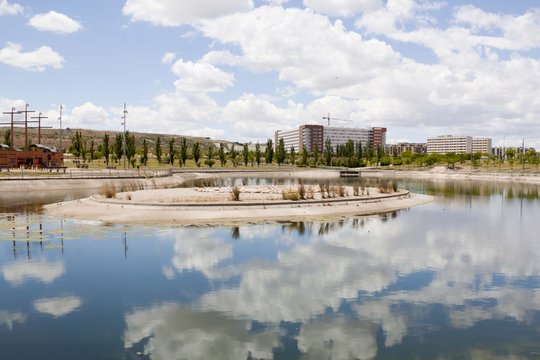 clouds over a lake, a park and an urbanization in Zaragoza