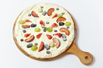 Sweet pizza with fruits and berries on white background