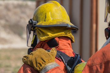 firefighter hand put on shoulder of first man for signal in fire