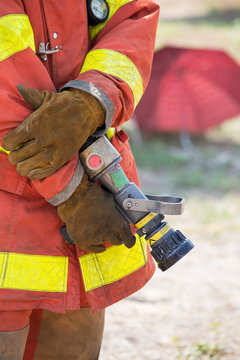 fireman hand in glove hold fire branch in standby position