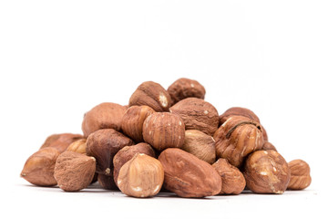 Pile of hazelnuts with copy space over white background
