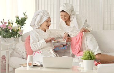 Fototapeta na wymiar women wearing a white bathrobes with laptop