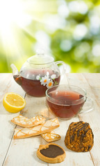 Image of cookies, cup of tea and lemon close up