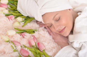 woman wearing a white bathrobe sleeping