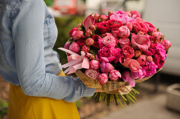 girl holding a bouquet of pink flowers