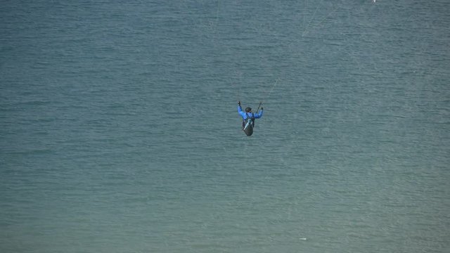 Paragliders soar over the sea