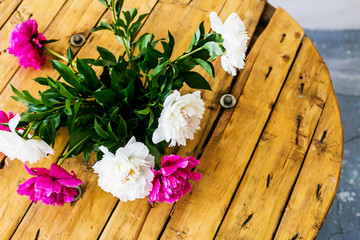 Large peony flowers on wooden background