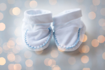 close up of white baby bootees for newborn boy
