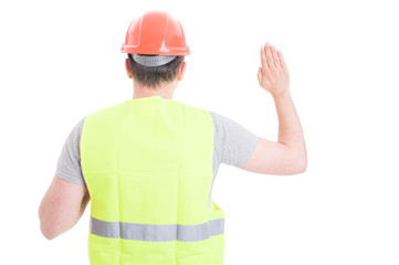 Back view of male constructor standing and doing a vow