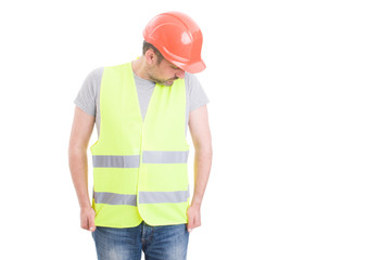 Young constructor wearing hardhat and reflective yellow vest