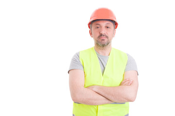 Confident handsome constructor with helmet and protection vest