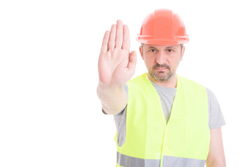 Constructor in protection equipment doing stop gesture