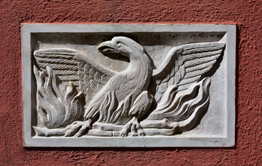 Fototapeta premium Phoenix Theatre Sign. Old Patera (Venice public art) with phoenix theatre symbol on a wall near the famous opera house